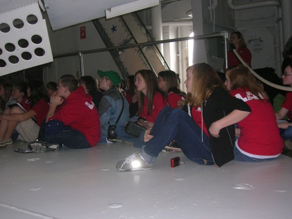E. L. Wright students beneath the dive flaps (see the holes in the flaps to prevent flutter) of the SBD, which helped make it the most deadly bomber in the Pacific War.