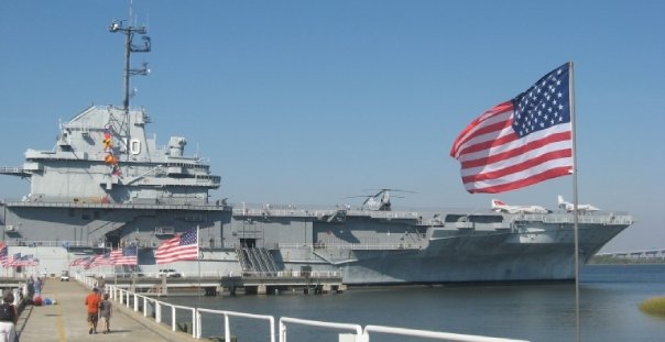 USS Yorktown and a pier of flags.