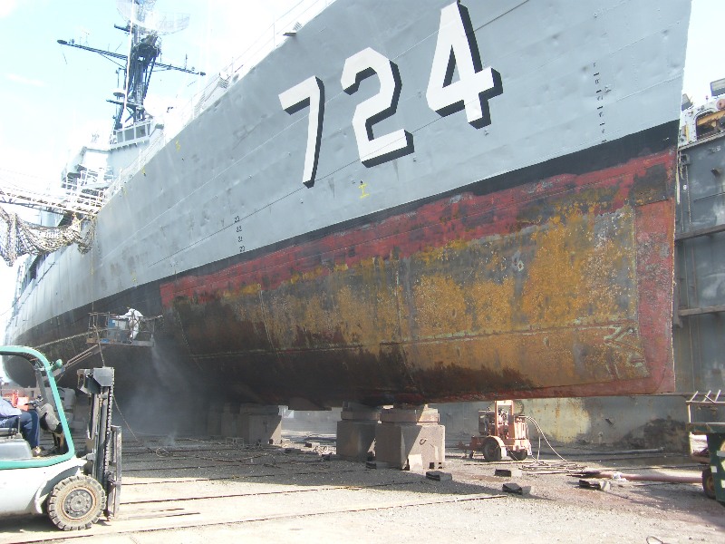 USS Laffey on blocks in dry dock and being prepped for serious work.