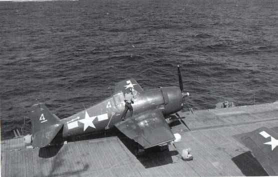 f6f F-6F-5E fighter on USS Sangamon in April 1945 (notice radar pod, white, under the wingtip).