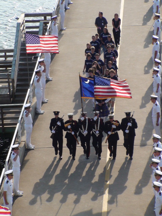 Color guard and Moultrie Middle school 8th graders process down the pier to Yorktown.