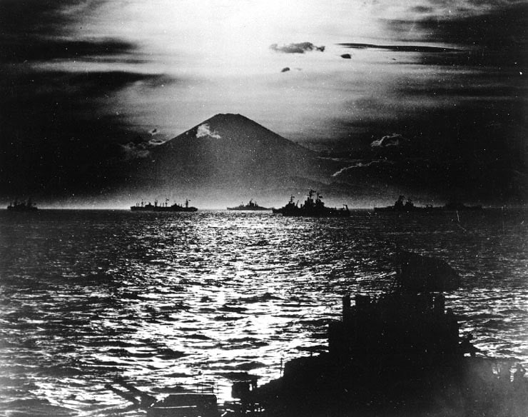 With Allied warships anchored in Sagami Wan, the sun sets behind Mt. Fugiyama and on the Japanese Empire.