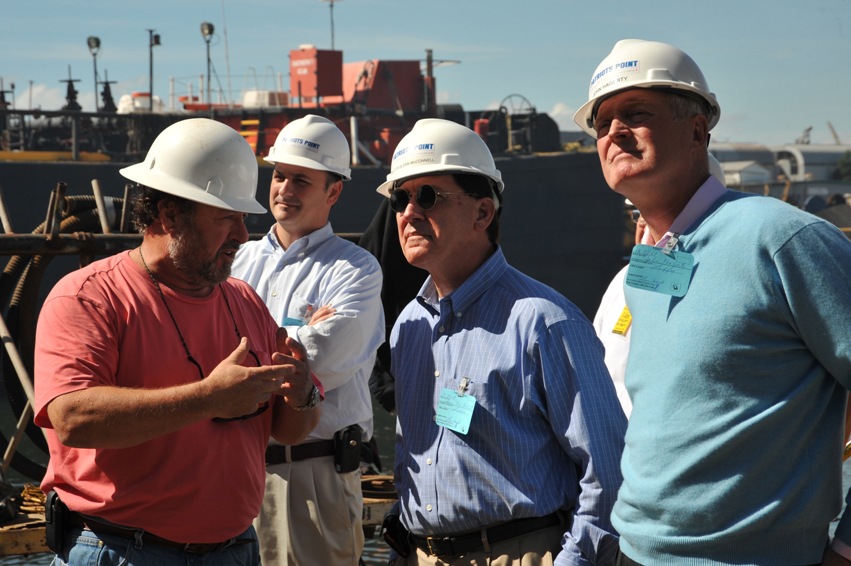 Senator McConnell and PPDA Chairman Hagerty listen to Detyen's shipyard workers explain their work.
