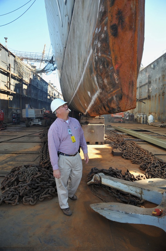 Executive director Dick Trammel inspects repairs on the bow of Laffey.