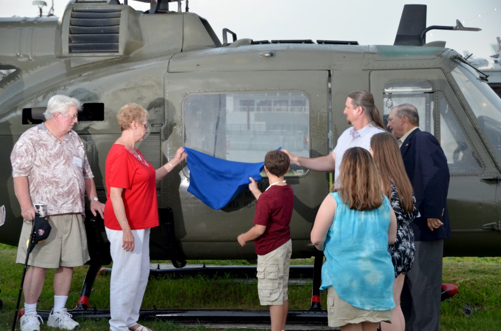 The family of Kenneth Plavcan unveils the new honor on the side of the Huey
