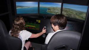 Teachers take a turn flying a jet in the flight simulators at Patriots Point