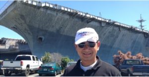 Lt. Col. Lan Dalat in front of the USS Ranger.  The carrier rescued him and 138 other Vietnamese refugees in 1981 after several weeks at sea. 