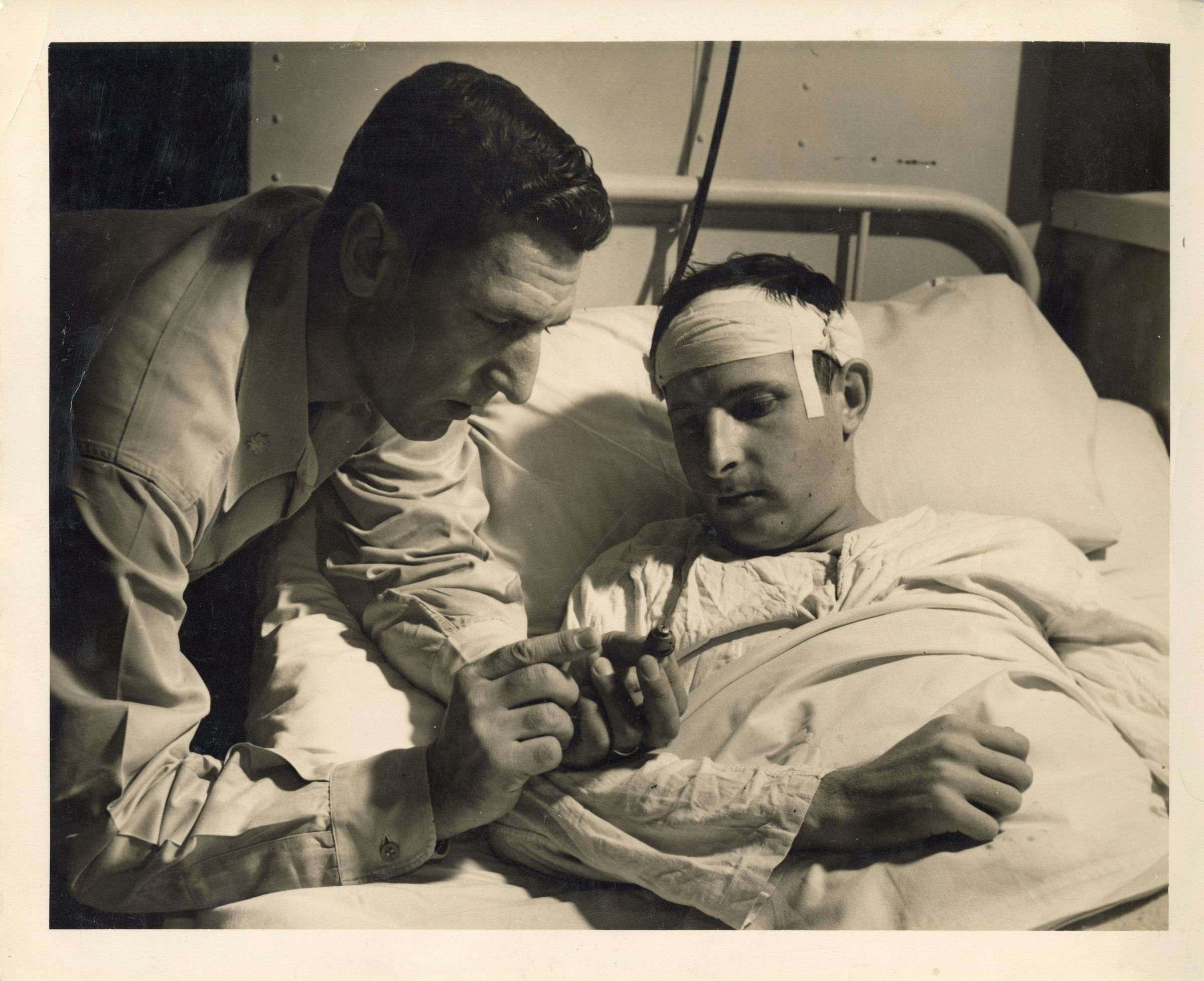 Primary Image of Lt. Thienes Viewing Shrapnel