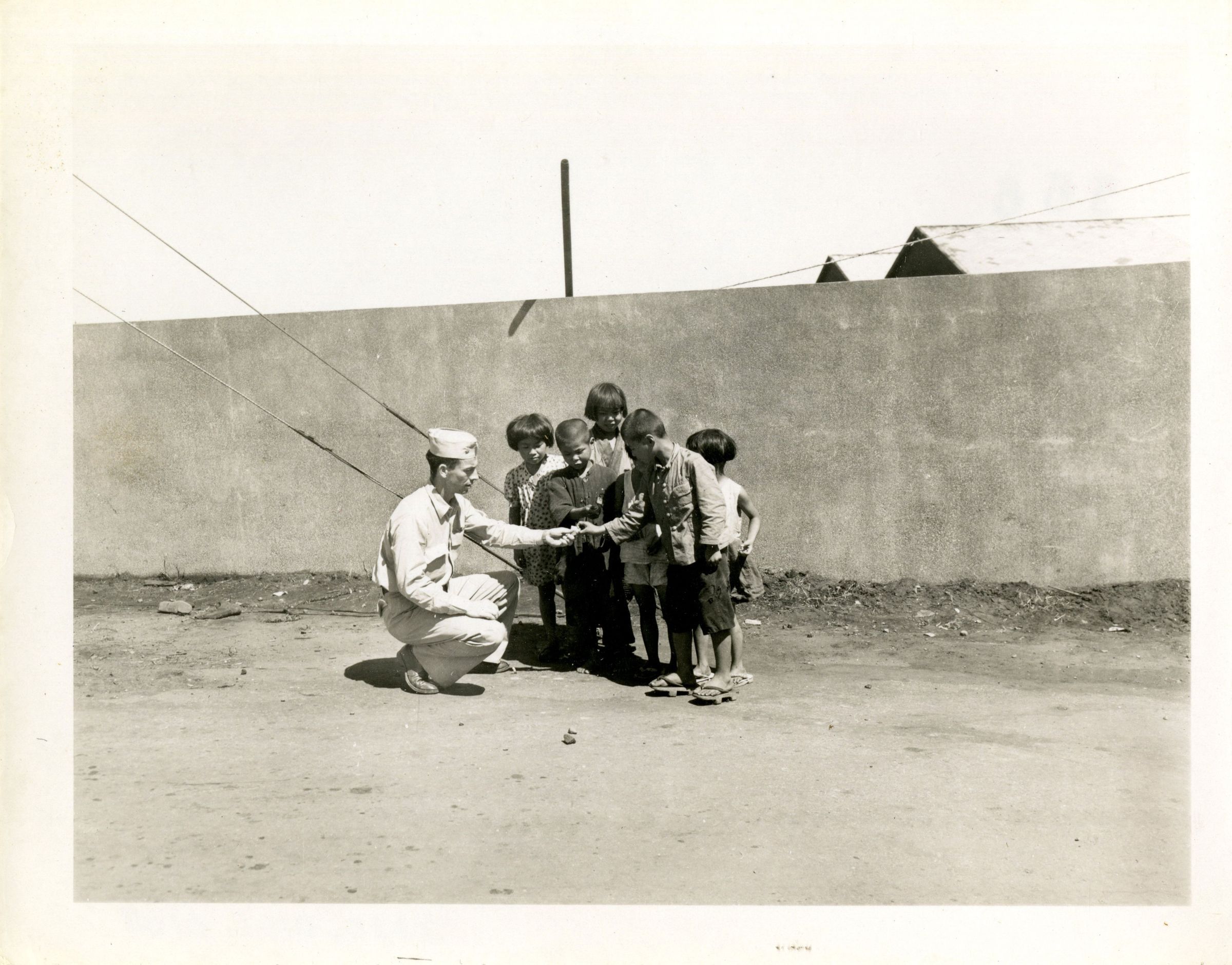 Primary Image of Irven Klug Giving Candy to Children