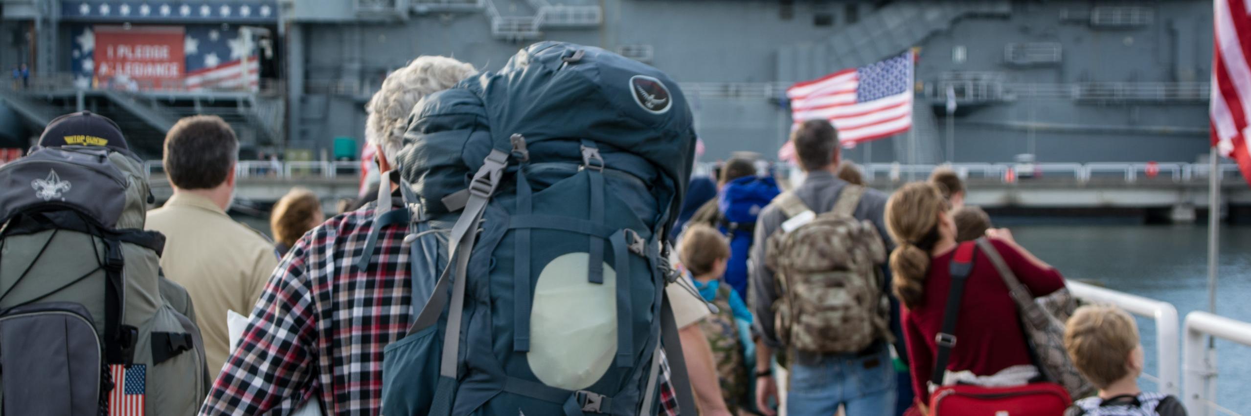 People carrying on backpacks and overnight bags for Operation Overnight