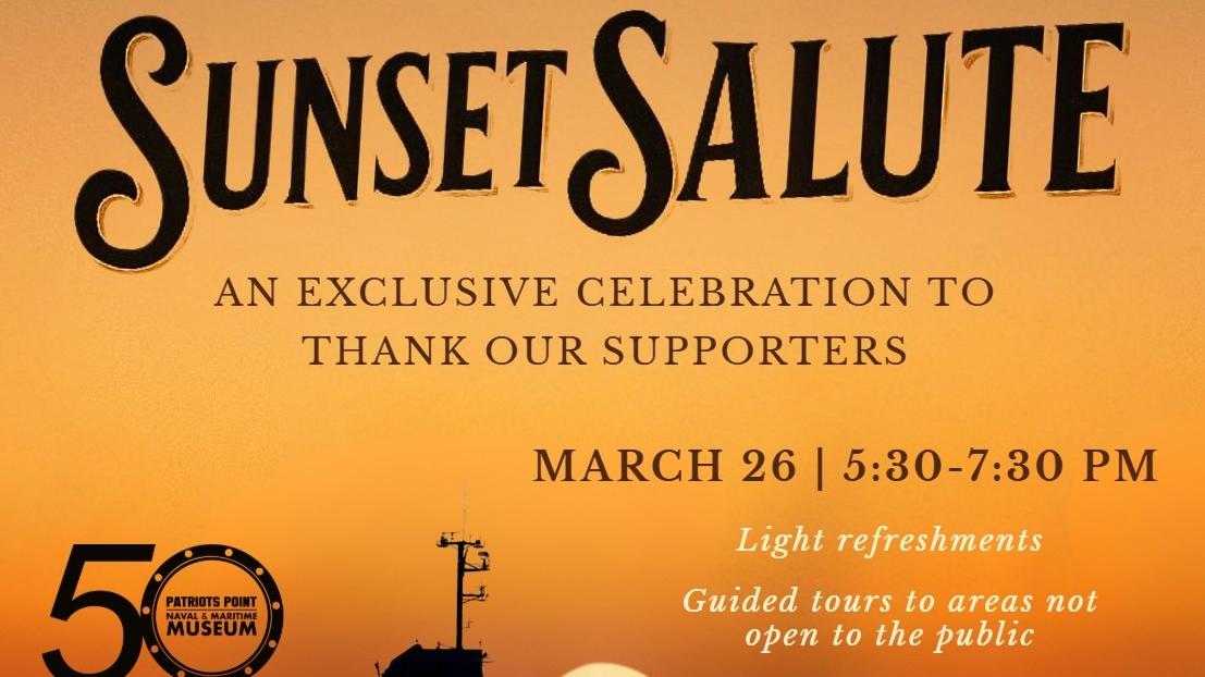 Aircraft carrier with sun setting in the background.