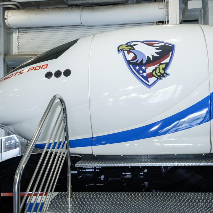 View of steps leading up to a flight simulator pod. 