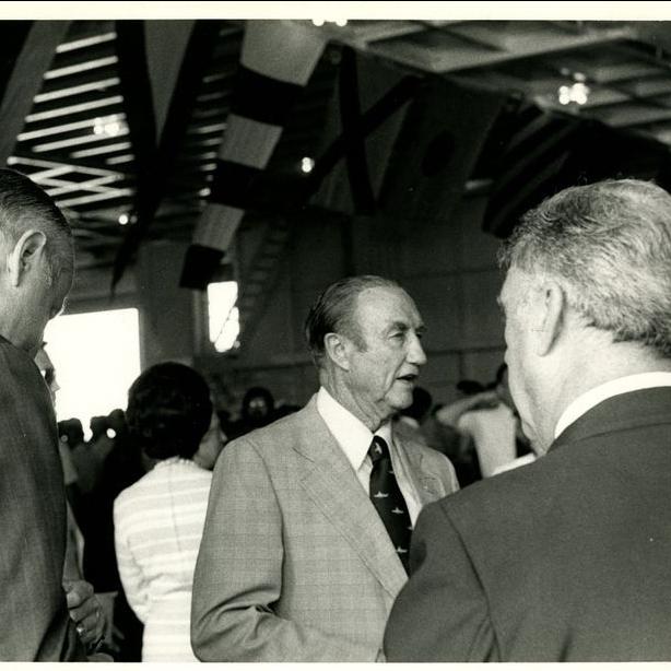 This photograph shows Strom Thurmond speaking with 2 men on the hangar bay during the opening day ceremonies aboard the USS Yorktown, January 3, 1976.