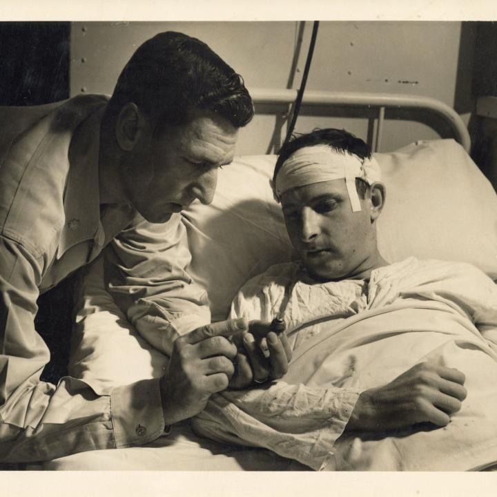 Primary Image of Lt. Thienes Viewing Shrapnel