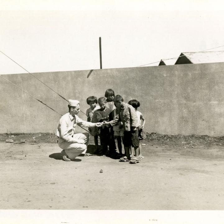 Primary Image of Irven Klug Giving Candy to Children