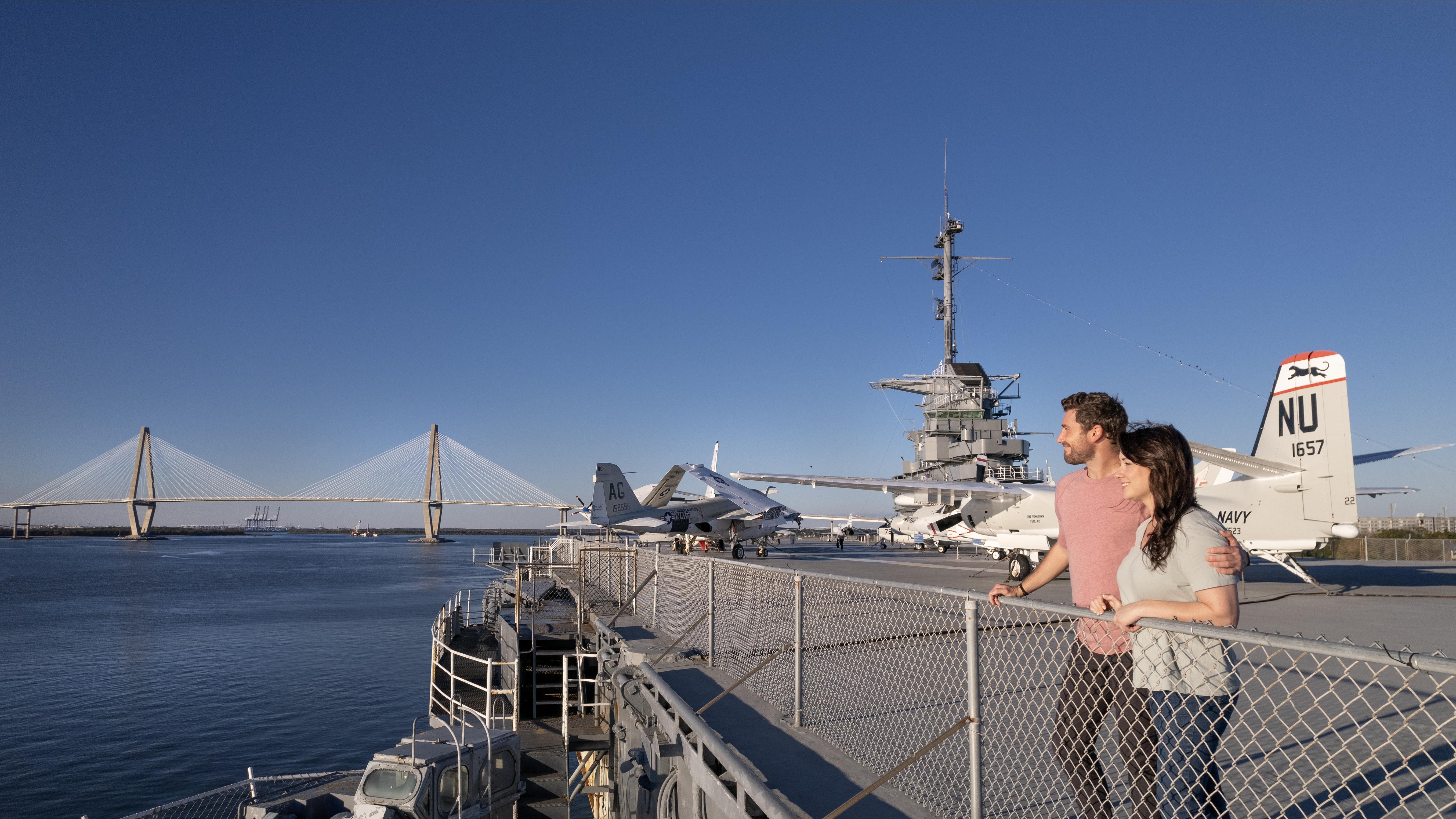 Woman and man stand on the flight deck of the USS Yorktown.