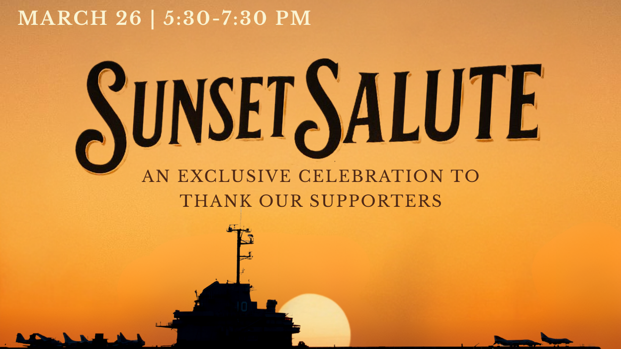 Naval aircraft carrier with sunset backdrop.