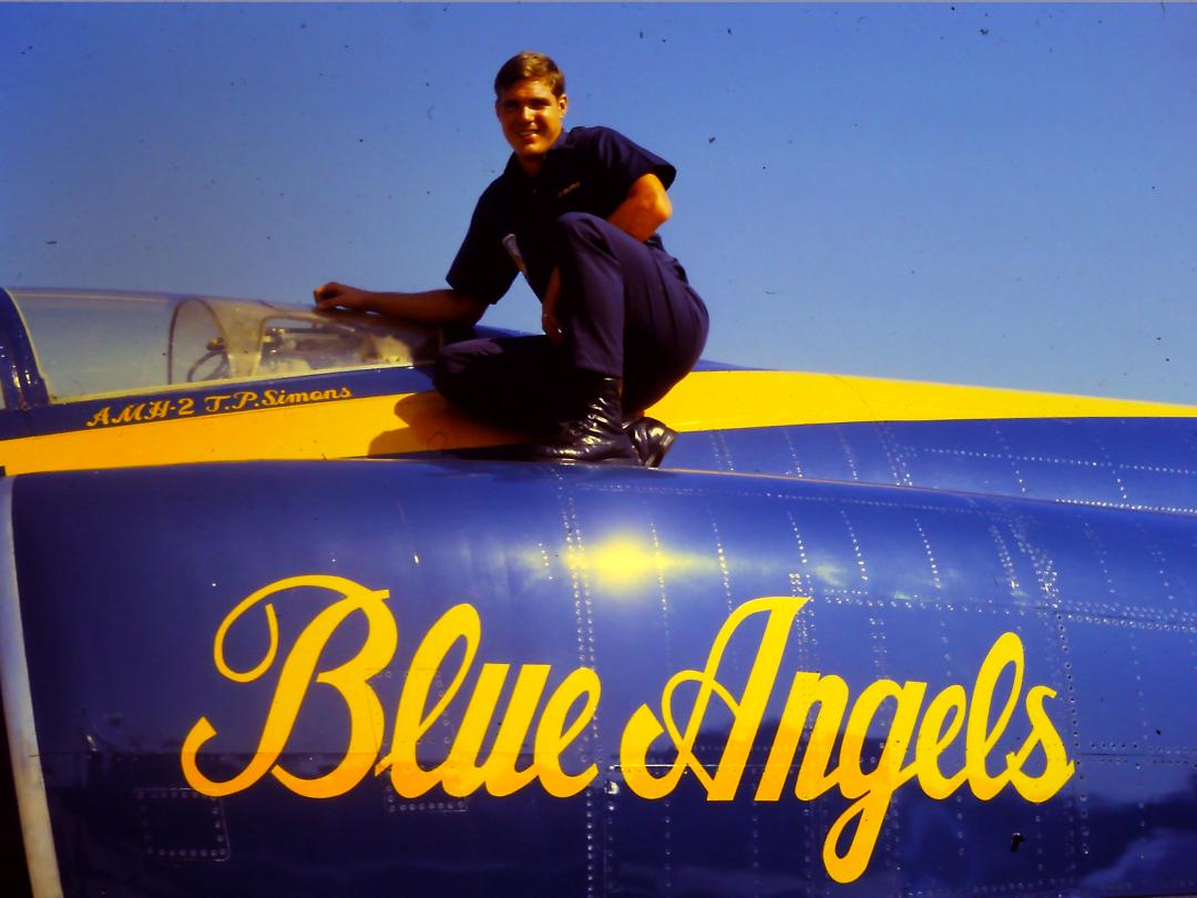 Veteran Tom Simons sits atop a Blue Angels jet.