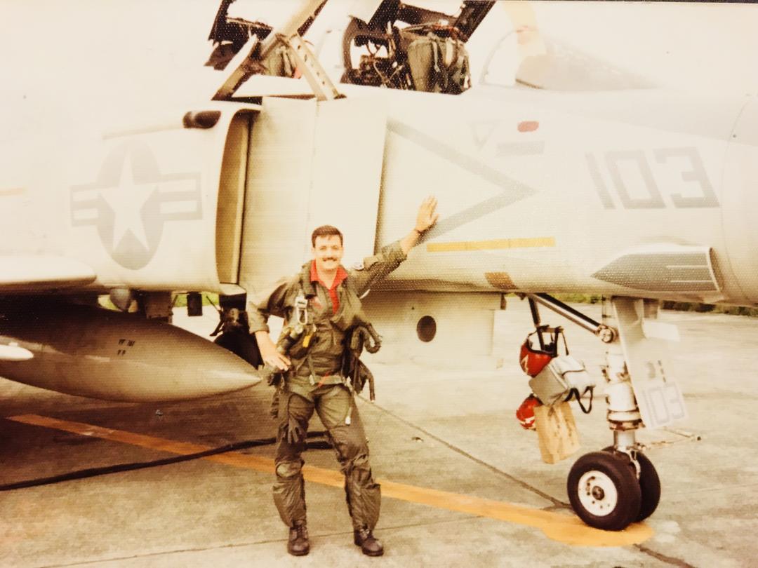 Image of Tom Hendricks posing in front of an aircraft. 